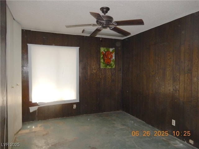 3175 Palmdale St, Las Vegas, NV 89121 - empty room featuring wooden walls, unfinished concrete floors, and ceiling fan