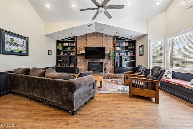 3930 Maranatha Cir, Las Vegas, NV 89103 - living area with lofted ceiling, built in features, ceiling fan, light wood-type flooring, and a brick fireplace