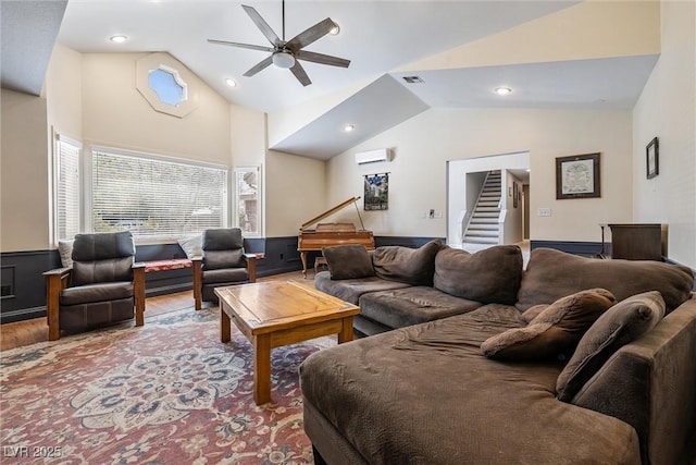 3930 Maranatha Cir, Las Vegas, NV 89103 - living room featuring stairway, ceiling fan, a wall unit AC, high vaulted ceiling, and wood finished floors