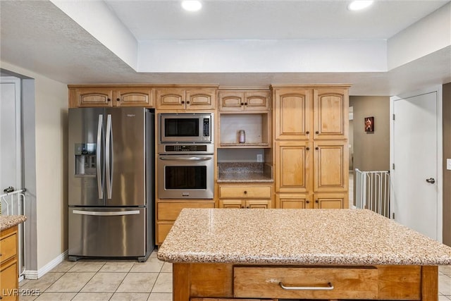 3930 Maranatha Cir, Las Vegas, NV 89103 - kitchen featuring stainless steel appliances, light tile patterned floors, light stone countertops, a kitchen island, and recessed lighting