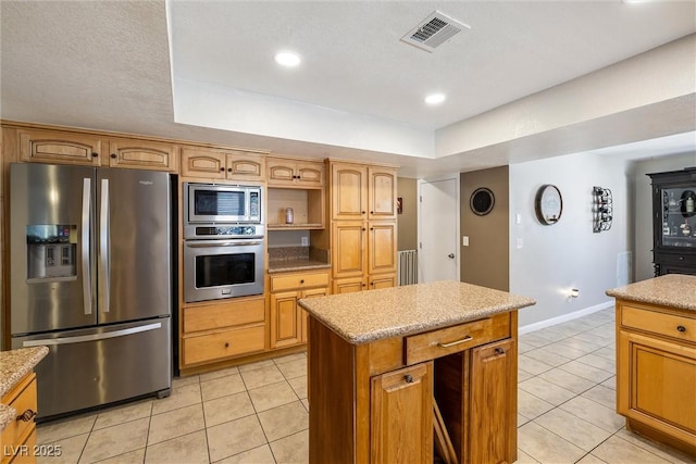 3930 Maranatha Cir, Las Vegas, NV 89103 - kitchen with appliances with stainless steel finishes, light tile patterned floors, a tray ceiling, a kitchen island, and recessed lighting
