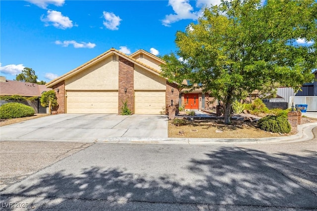 3930 Maranatha Cir, Las Vegas, NV 89103 - view of front of property featuring a garage, driveway, brick siding, and stucco siding