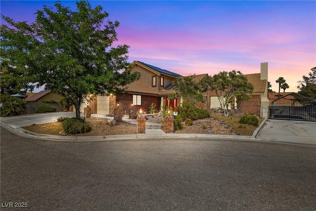 3930 Maranatha Cir, Las Vegas, NV 89103 - view of front facade with concrete driveway, roof mounted solar panels, a tile roof, and stucco siding