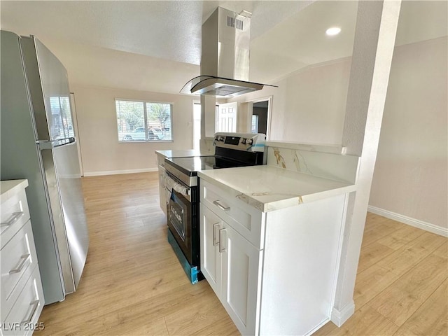 604 N Minnesota St, Las Vegas, NV 89107 - kitchen with stainless steel appliances, island exhaust hood, white cabinets, light wood finished floors, and recessed lighting