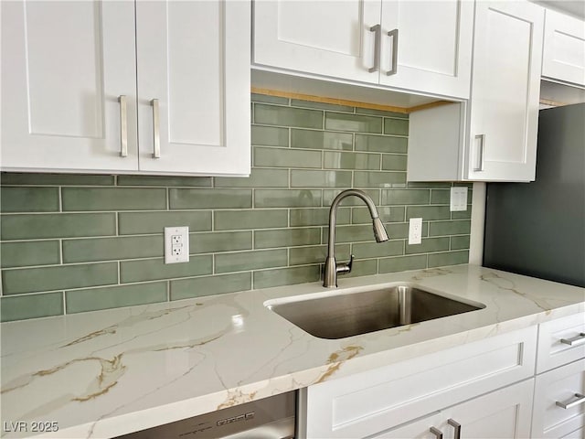 604 N Minnesota St, Las Vegas, NV 89107 - kitchen with white cabinetry, decorative backsplash, and light stone countertops