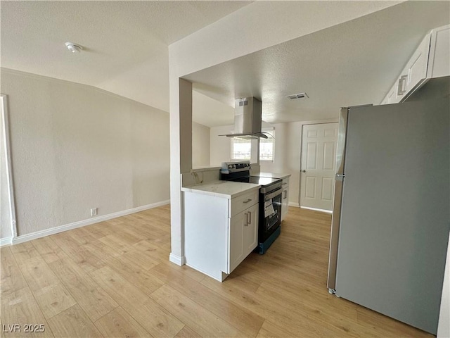 604 N Minnesota St, Las Vegas, NV 89107 - kitchen featuring stainless steel appliances, island exhaust hood, white cabinetry, light wood-style floors, and a textured ceiling