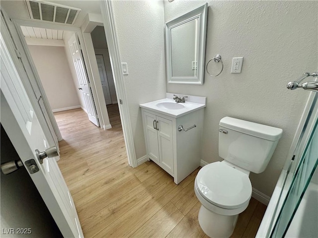 604 N Minnesota St, Las Vegas, NV 89107 - bathroom featuring vanity, wood finished floors, and a textured wall
