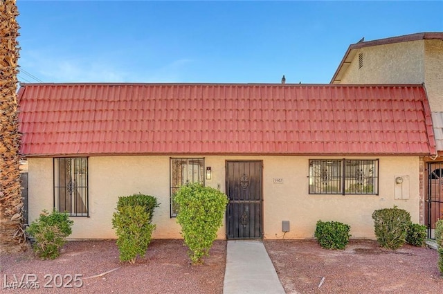 3907 Torsby Pl, Las Vegas, NV 89119 - view of front of property with a tiled roof and stucco siding