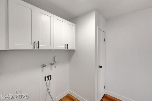 3907 Torsby Pl, Las Vegas, NV 89119 - laundry area featuring cabinet space and wood finished floors