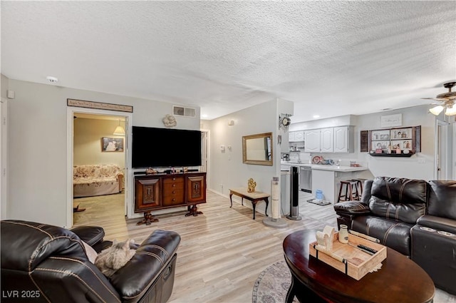 700 Capri Dr Unit 27B, Boulder City, NV 89005 - living area with light wood finished floors, a textured ceiling, and a ceiling fan