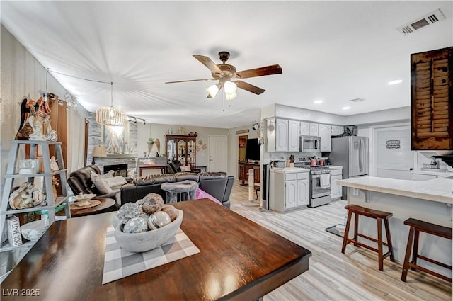 700 Capri Dr Unit 27B, Boulder City, NV 89005 - dining space with light wood-type flooring, ceiling fan, a fireplace, and recessed lighting
