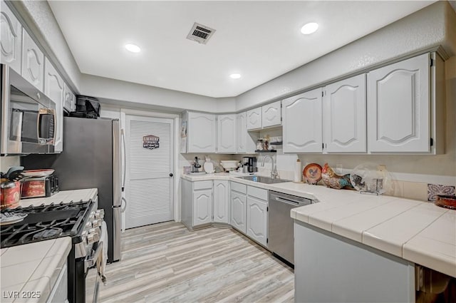 700 Capri Dr Unit 27B, Boulder City, NV 89005 - kitchen with appliances with stainless steel finishes, tile countertops, light wood finished floors, and recessed lighting