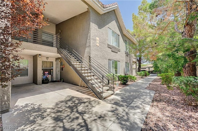 700 Capri Dr Unit 27B, Boulder City, NV 89005 - view of home's exterior featuring stucco siding, stairway, and a patio area