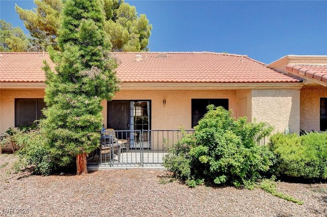 2851 S Valley View Blvd Unit 1039, Las Vegas, NV 89102 - back of house with stucco siding and a tiled roof