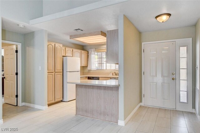 2851 S Valley View Blvd Unit 1039, Las Vegas, NV 89102 - kitchen featuring freestanding refrigerator, light brown cabinetry, a peninsula, light countertops, and dishwasher