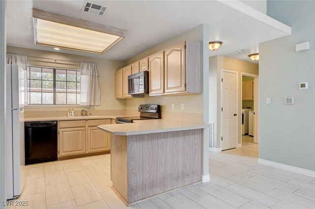 2851 S Valley View Blvd Unit 1039, Las Vegas, NV 89102 - kitchen with stainless steel electric range, black dishwasher, light brown cabinets, freestanding refrigerator, and washing machine and dryer