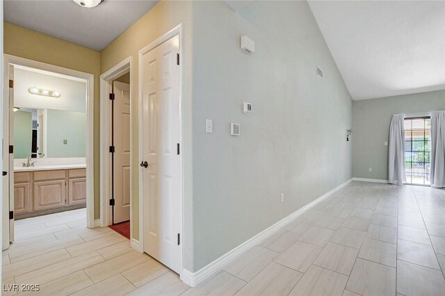 2851 S Valley View Blvd Unit 1039, Las Vegas, NV 89102 - hall with a sink and vaulted ceiling
