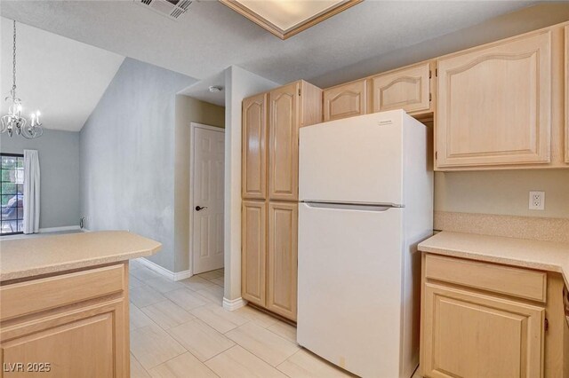 2851 S Valley View Blvd Unit 1039, Las Vegas, NV 89102 - kitchen with freestanding refrigerator, light brown cabinetry, light countertops, and a chandelier