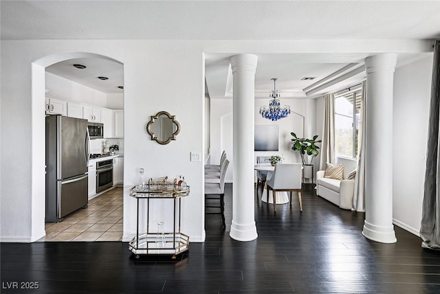 9430 Laguna Niguel Dr Unit 203, Las Vegas, NV 89134 - kitchen with stainless steel appliances, white cabinetry, and light wood finished floors