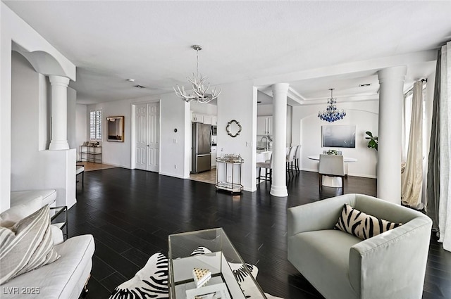 9430 Laguna Niguel Dr Unit 203, Las Vegas, NV 89134 - living room with decorative columns, a chandelier, and wood finished floors