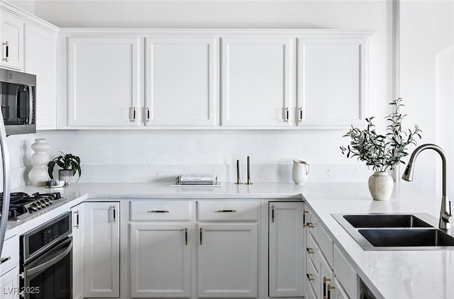 9430 Laguna Niguel Dr Unit 203, Las Vegas, NV 89134 - kitchen featuring stainless steel appliances, white cabinets, and light countertops