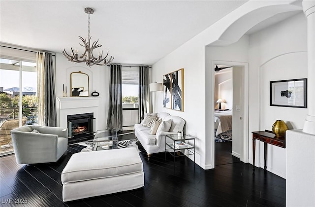 9430 Laguna Niguel Dr Unit 203, Las Vegas, NV 89134 - living room with dark wood-type flooring, arched walkways, and plenty of natural light