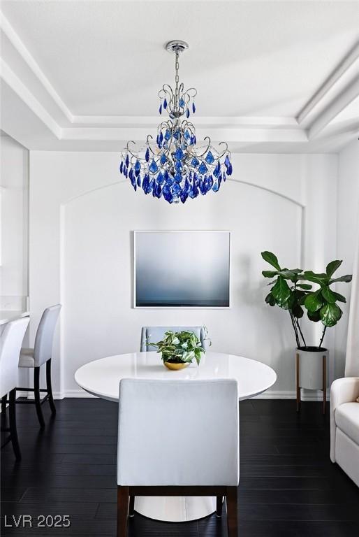9430 Laguna Niguel Dr Unit 203, Las Vegas, NV 89134 - dining space featuring dark wood finished floors, a tray ceiling, and a chandelier