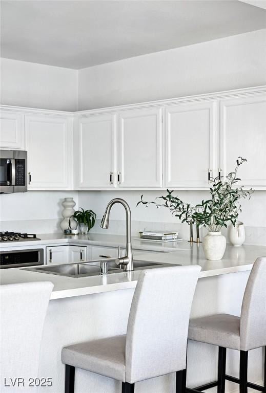 9430 Laguna Niguel Dr Unit 203, Las Vegas, NV 89134 - kitchen with appliances with stainless steel finishes, white cabinetry, and light countertops