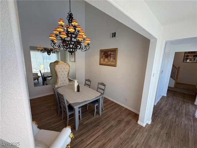 1146 Olivia Pkwy, Henderson, NV 89011 - dining room with wood finished floors, a chandelier, stairs, and a high ceiling