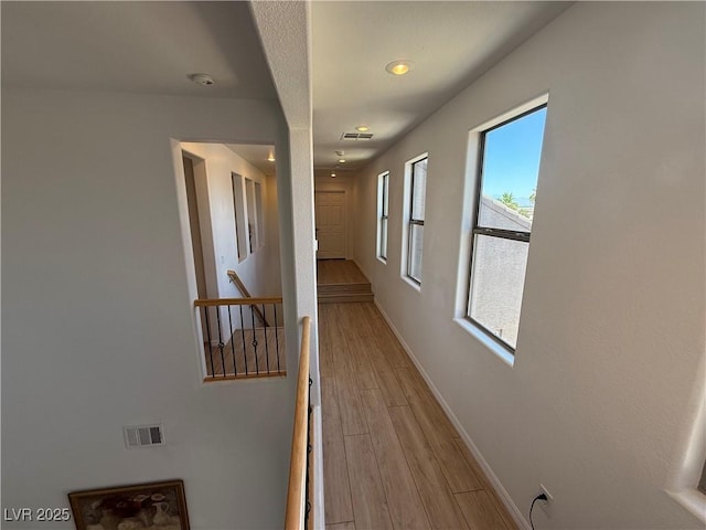 1146 Olivia Pkwy, Henderson, NV 89011 - hallway with light wood-style flooring and an upstairs landing