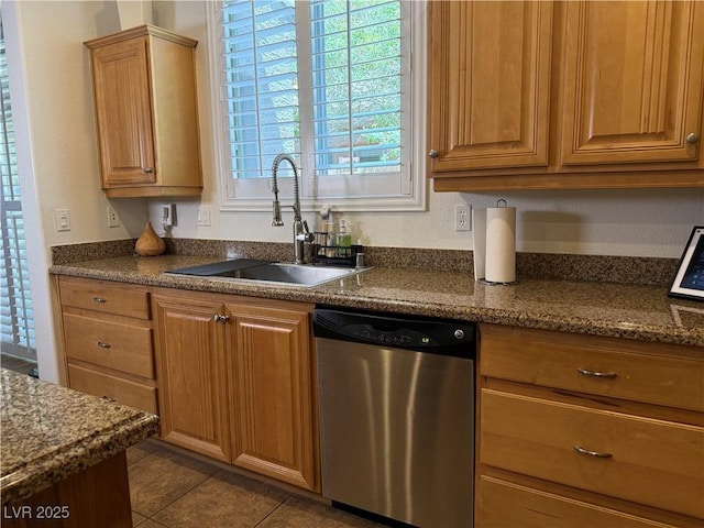 1146 Olivia Pkwy, Henderson, NV 89011 - kitchen featuring stainless steel dishwasher, dark tile patterned floors, and brown cabinets