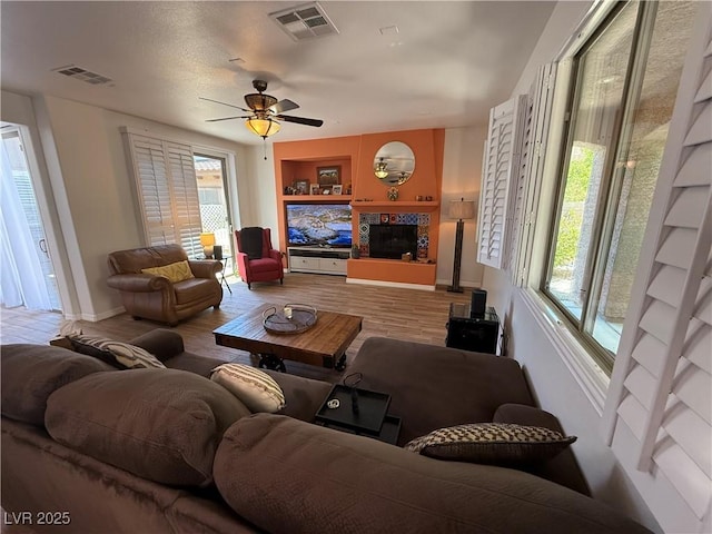1146 Olivia Pkwy, Henderson, NV 89011 - living area featuring healthy amount of natural light, a ceiling fan, wood finished floors, and built in shelves