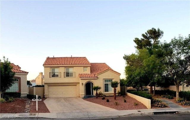2140 Desert Peak Rd, Las Vegas, NV 89134 - mediterranean / spanish house with a tiled roof, stucco siding, concrete driveway, and a garage