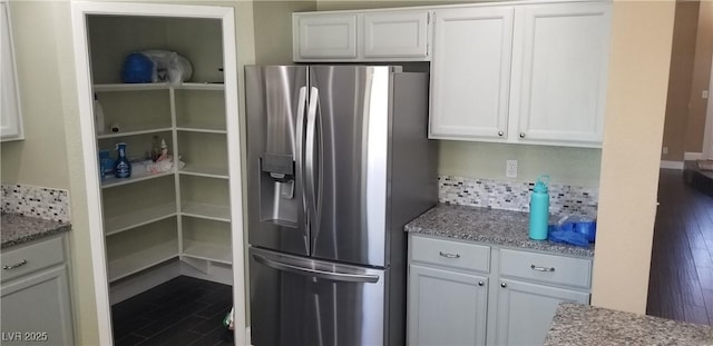 2140 Desert Peak Rd, Las Vegas, NV 89134 - kitchen featuring stainless steel fridge with ice dispenser, dark wood-style floors, white cabinets, and light stone countertops