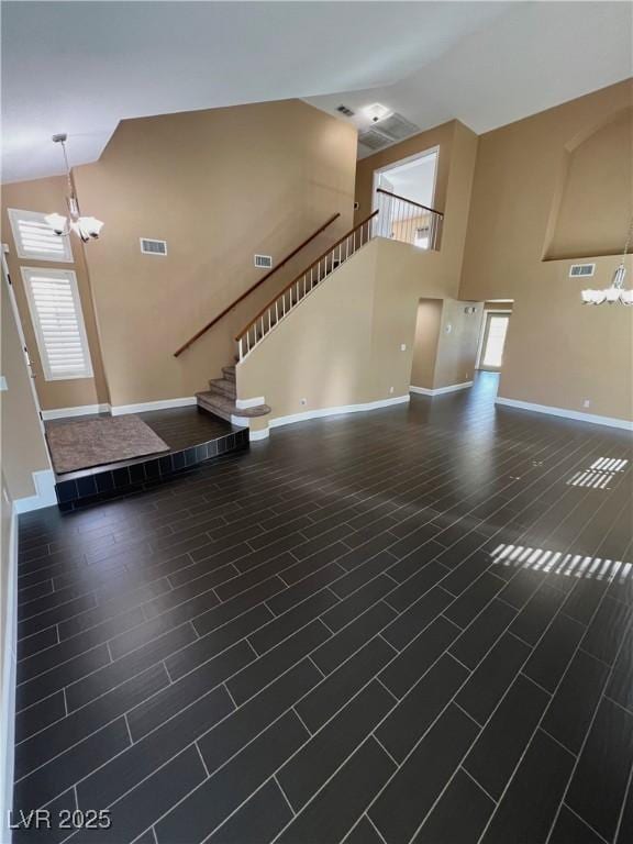 2140 Desert Peak Rd, Las Vegas, NV 89134 - unfurnished living room with a chandelier, high vaulted ceiling, and stairs