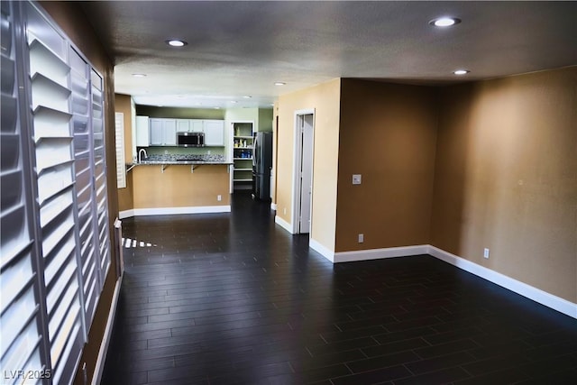 2140 Desert Peak Rd, Las Vegas, NV 89134 - unfurnished living room featuring dark wood finished floors and recessed lighting