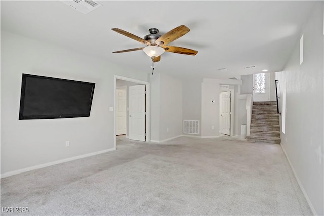 9784 Kodiak Island Ct, Las Vegas, NV 89141 - unfurnished living room with stairway, a ceiling fan, and light colored carpet