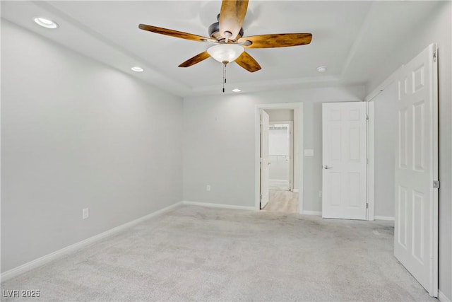 9784 Kodiak Island Ct, Las Vegas, NV 89141 - unfurnished bedroom featuring light carpet, recessed lighting, a tray ceiling, and a ceiling fan
