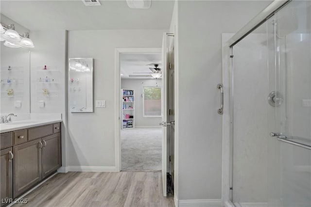 9784 Kodiak Island Ct, Las Vegas, NV 89141 - full bathroom featuring vanity, a stall shower, wood finished floors, and ceiling fan