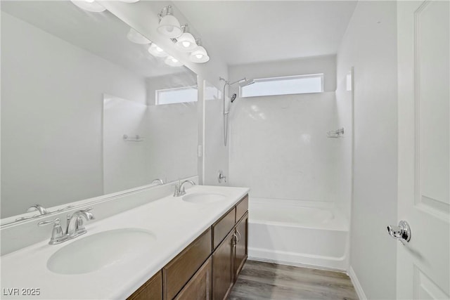 9784 Kodiak Island Ct, Las Vegas, NV 89141 - bathroom with double vanity, plenty of natural light, wood finished floors, and bathing tub / shower combination