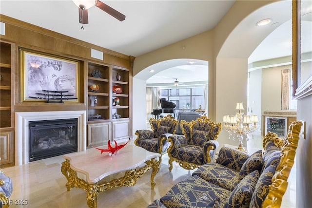 9101 Alta Dr Unit 301, Las Vegas, NV 89145 - living room with a glass covered fireplace, a ceiling fan, arched walkways, wine cooler, and built in features