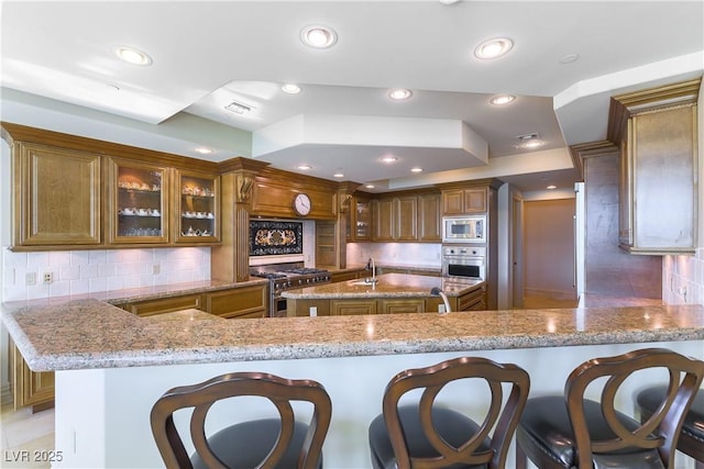 9101 Alta Dr Unit 301, Las Vegas, NV 89145 - kitchen with appliances with stainless steel finishes, light stone countertops, tasteful backsplash, and recessed lighting