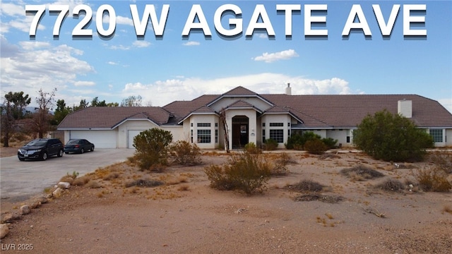 7720 W Agate Ave, Las Vegas, NV 89113 - view of front facade with a tiled roof, driveway, and a garage