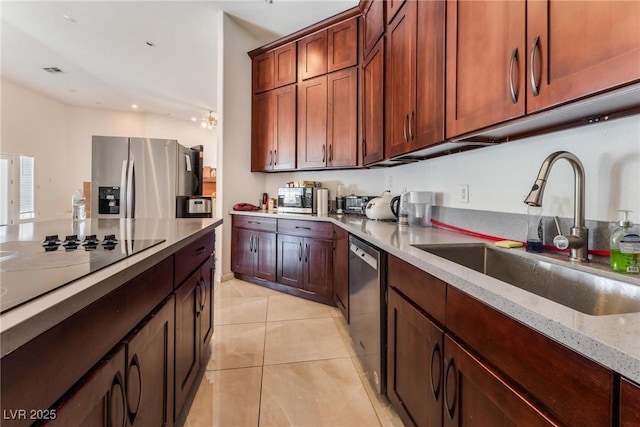 7720 W Agate Ave, Las Vegas, NV 89113 - kitchen with stainless steel appliances, light tile patterned floors, light stone counters, and recessed lighting