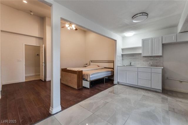 7720 W Agate Ave, Las Vegas, NV 89113 - kitchen featuring backsplash, light countertops, and light wood-style flooring