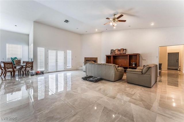 7720 W Agate Ave, Las Vegas, NV 89113 - living area with a high ceiling, a ceiling fan, light marble finish flooring, and recessed lighting