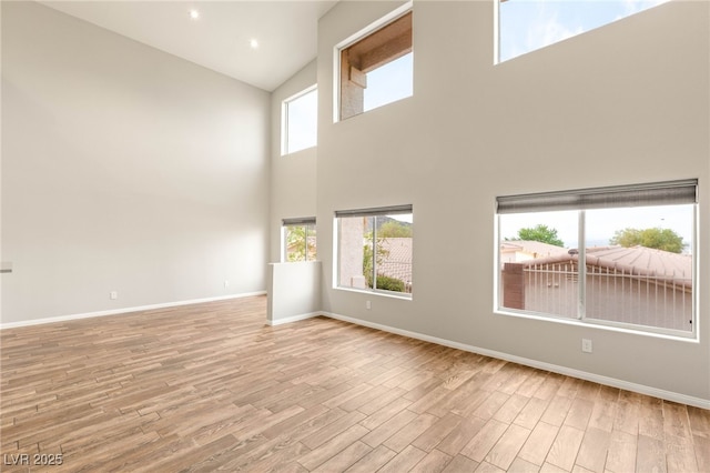 251 Big Horn Dr, Boulder City, NV 89005 - spare room with high vaulted ceiling, wood finished floors, and plenty of natural light