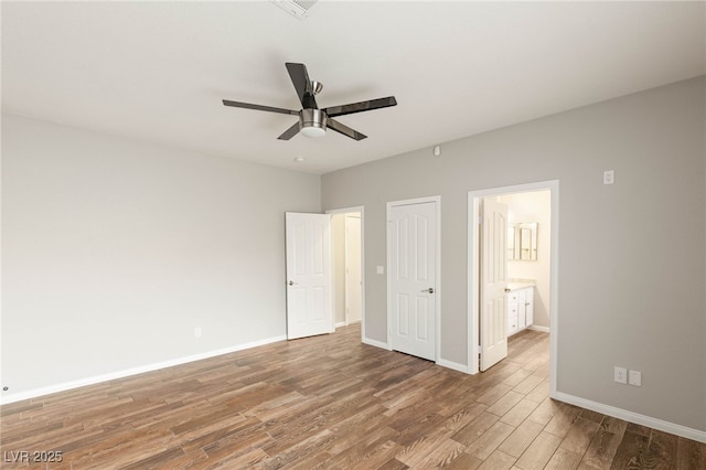 251 Big Horn Dr, Boulder City, NV 89005 - unfurnished bedroom featuring wood finished floors, connected bathroom, and ceiling fan