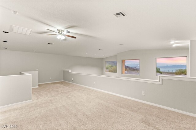 251 Big Horn Dr, Boulder City, NV 89005 - spare room featuring a ceiling fan, light colored carpet, vaulted ceiling, healthy amount of natural light, and a smoke detector