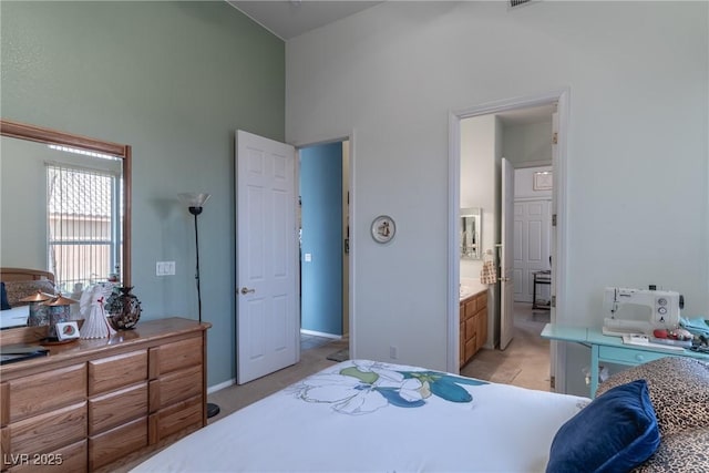 1239 N Hollywood Blvd, Las Vegas, NV 89110 - bedroom with high vaulted ceiling, light carpet, and ensuite bath